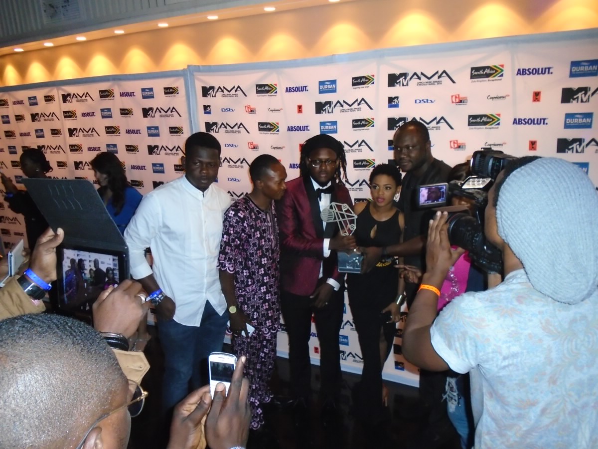 Clarence Peters poses with his award and fans.