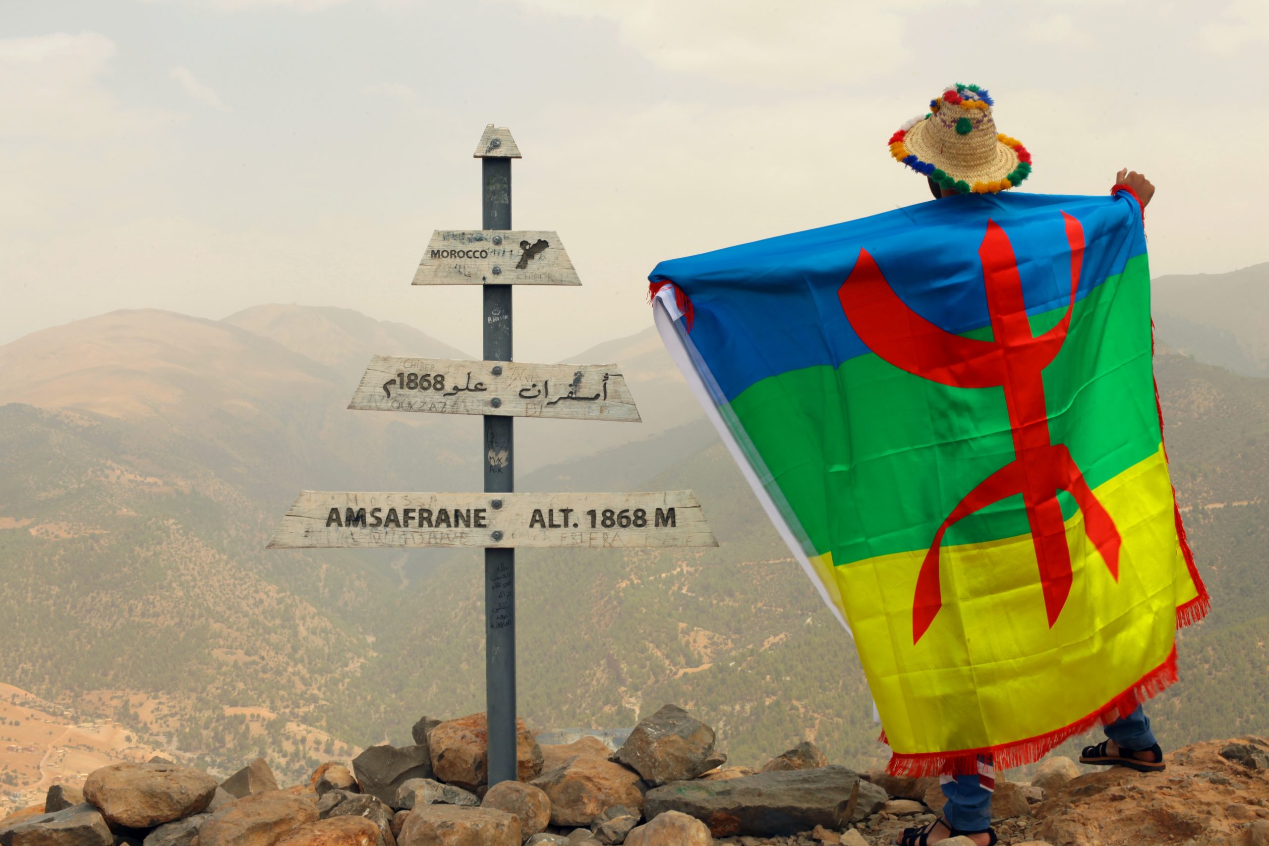 A,Moroccan,Man,Holding,The,Amazigh,Flag,In,Amsafrane,Summit