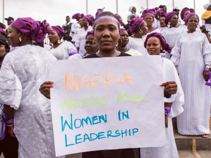 A,Woman,Holds,Up,A,Cardboard,That,Reads,-,Nigeria