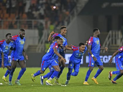 DR Congo national team players run and celebrate after defeating Egypt on penalties at the 2023 AFCON.