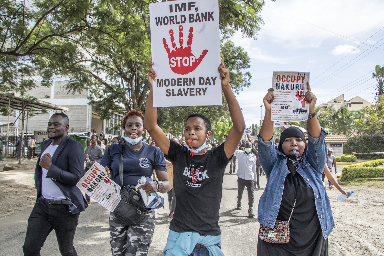 Protestors carry anti-IMF sign in Nakuru, Kenya.