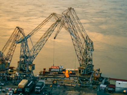 Two cranes on the Congo river at sunset.