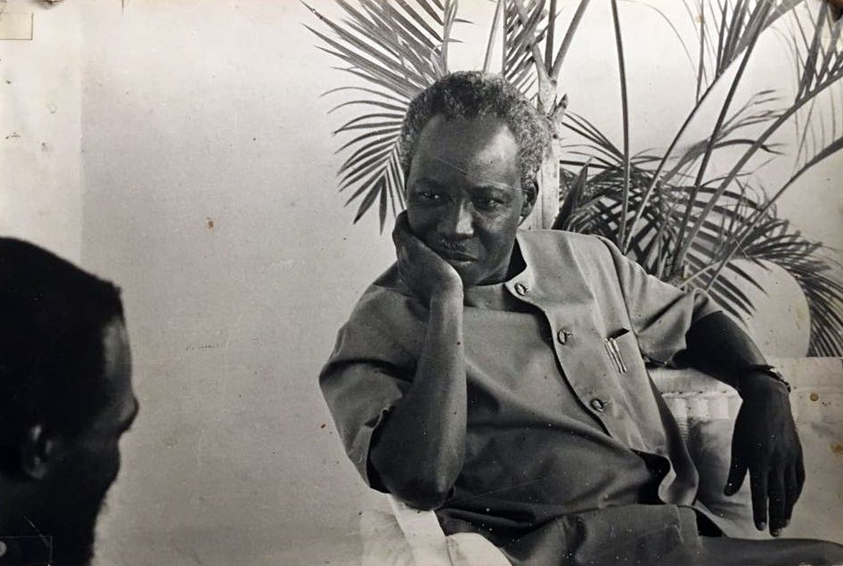 Black and white photo of two men in discussion.