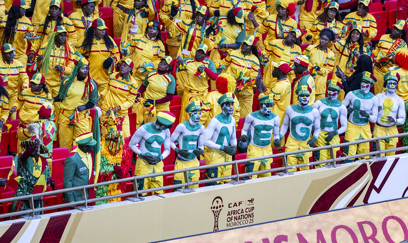 Fans of Senegal’s national football team cheer in the stands at the Africa Cup of Nations, with several supporters spelling out “SENEGAL” using body paint.