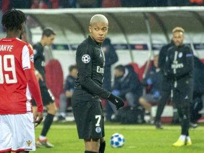 Kylian Mbappe looking at an opponent on the field.