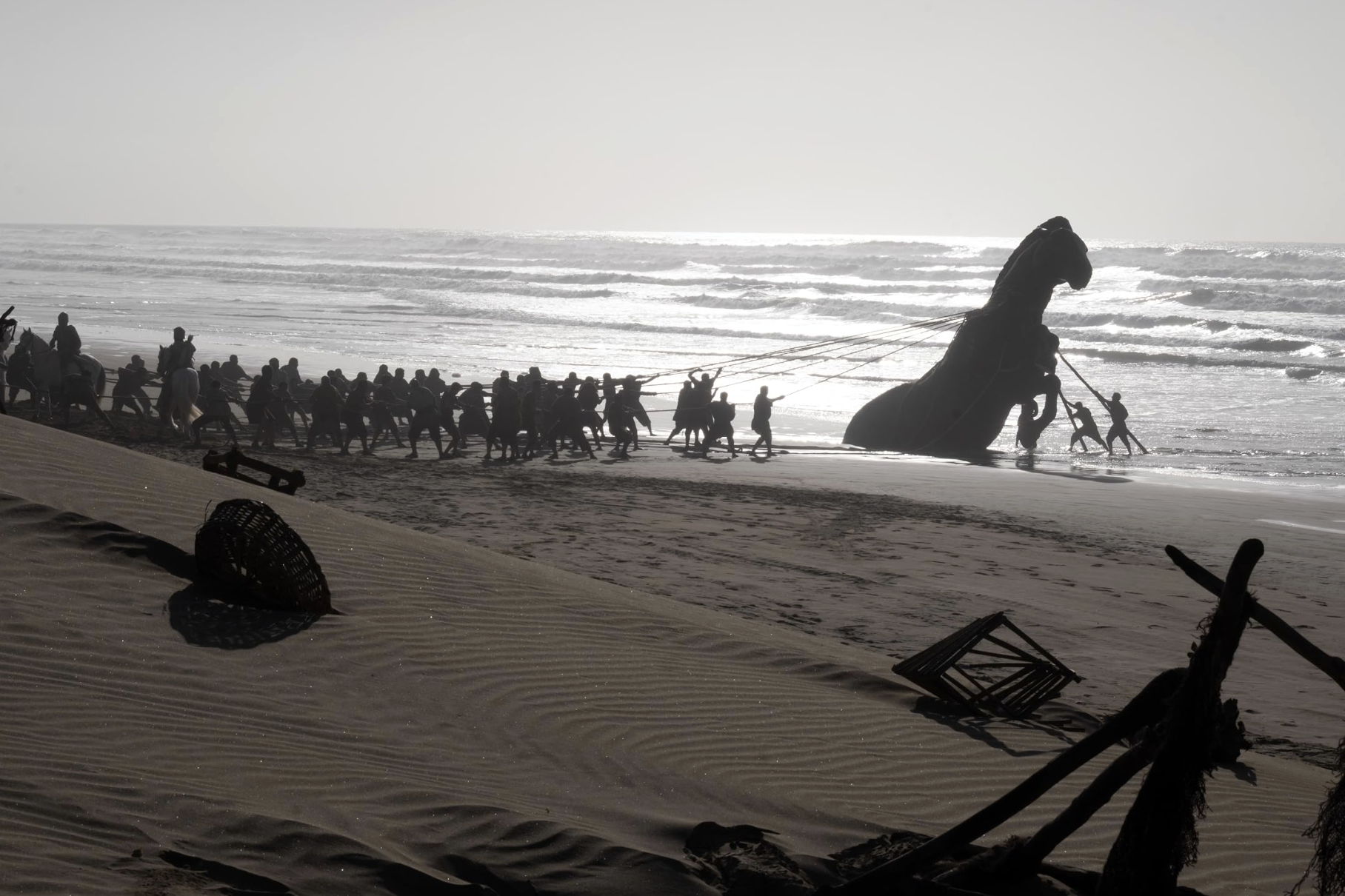 Film crew members pull a giant Trojan Horse prop from the Atlantic Ocean onto a beach during the filming of Christopher Nolan’s The Odyssey at Dakhla in occupied Western Sahara.
