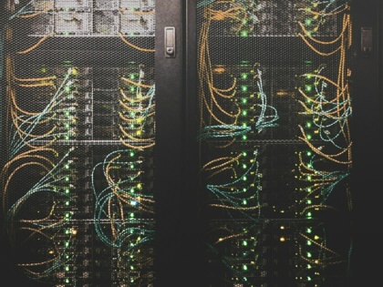 Layers of exposed, different colored cables on a network server.
