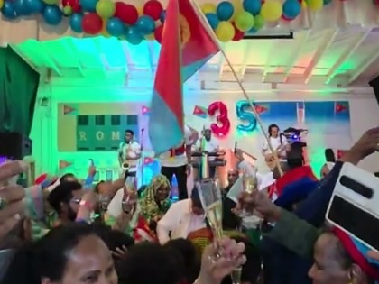 Eritrean diaspora celebrating in a community hall.