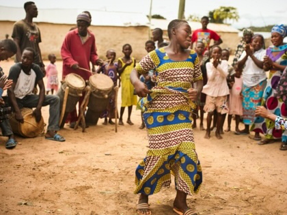 Woman dancing to traditional music in Ghana.